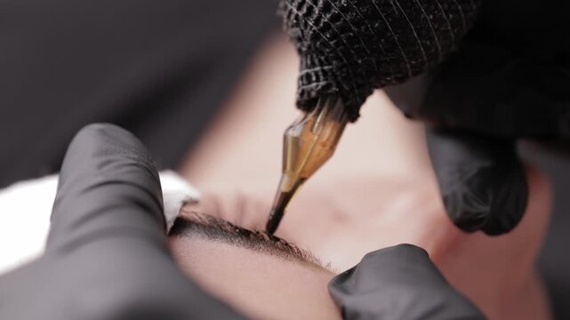 Top view eyebrow microblading process on caucasian female.