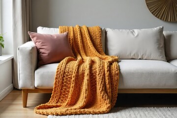 Soft, chunky knit throw blanket draped casually over a modern minimalist sofa, adding texture and warmth to the living room  Perfect for cozy autumn or winter scenes , scandi, room