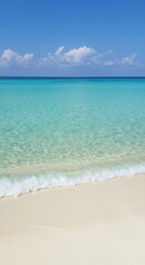 Fototapeta premium Idyllic tropical seascape showcasing pristine white sand, crystal clear turquoise water, and soft rolling ocean waves under bright sunlight ,coast ,turquoise ,peaceful