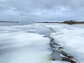 Ice melting on the Sheksna River in the abnormally warm winter of 2020. Russia, Vologda region