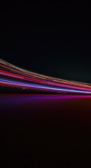 Dynamic long exposure shot capturing faint, mesmerizing trails of colorful residual light against a deep, dark abyss backdrop ,optical ,photography ,dark