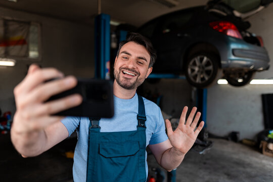 Mechanic interacts with customers while working in an auto repair shop