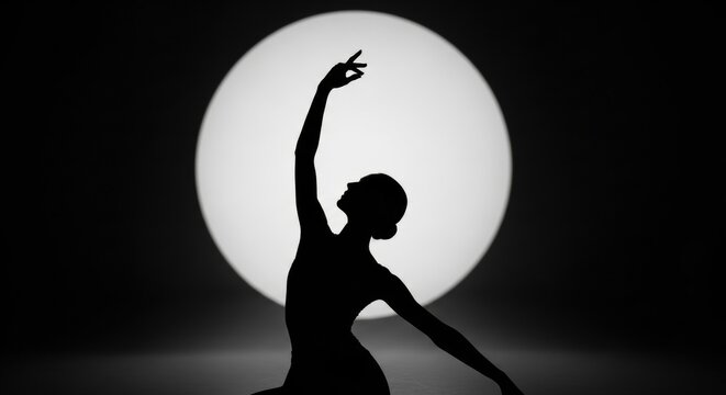 Silhouette of a graceful female dancer in a spotlight. Elegant ballet performance concept. Artistic black and white body form. Theatrical stage lighting for a solo artist's show