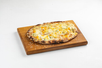 Freshly baked quattro formaggi pizza with melted cheese served on wooden board over white background