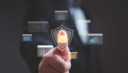 Businessman pressing virtual lock icon with data protection symbols representing cybersecurity, cloud storage security, privacy protection and digital information safety for modern business networks.