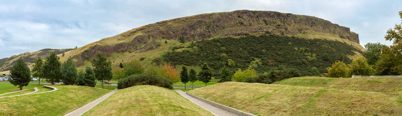 A panorama of Arthur's Seat and Salisbury Crags, Holyrood Park. This extinct volcano is a popular tourist attraction on the edge of Edinburgh, Scotland.