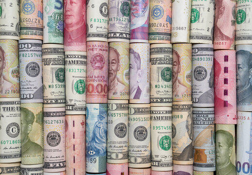 Rolled banknotes of various world currencies showing concept of currency exchange forex trading international finance global money transfer and economic investment market.