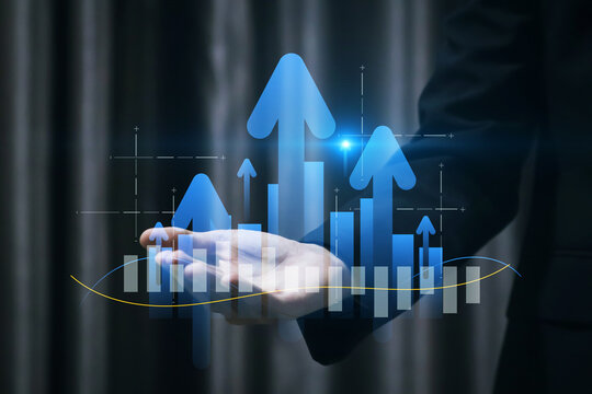 Businessman pointing at upward arrows with bar charts and data graphs, symbolizing financial growth, market success, business analytics, and future trend strategy, Performance Optimization. - Powered by Adobe