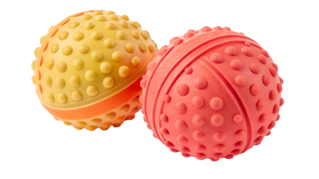 Two textured rubber balls, one yellow and one red, for pets, isolated on transparent background
