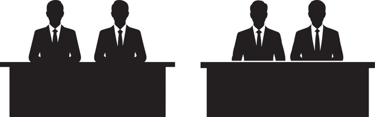 Four business people sitting at desks silhouette