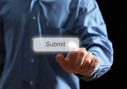 Hand touching virtual submit button on screen