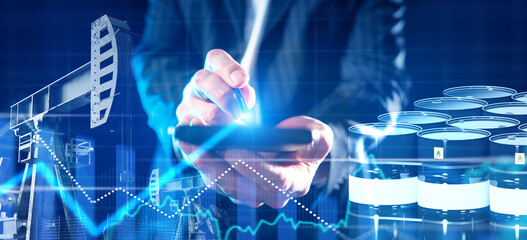 Oil industry analyst monitors production data and market trends using digital technology to manage...