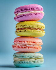 colorful french macarons stack on pastel background