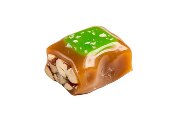 A green candy topped with nuts