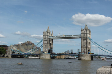 Obraz premium Tower Bridge spans the River Thames in London, showing its iconic structure against a clear blue sky