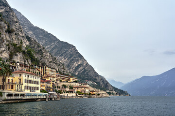Rocky mountainside and historic buildings of Limone Sul Garda on the shores of Lake Garda