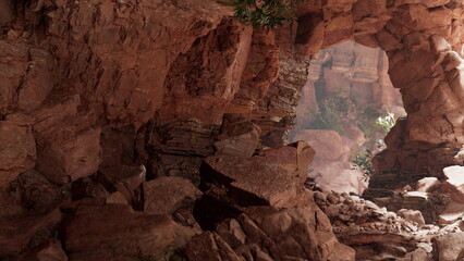 Obraz premium A rugged cave reveals stunning rock formations and scattered stones, illuminated by soft, natural light. Lush greenery peeks through the archway, enhancing the serene atmosphere.