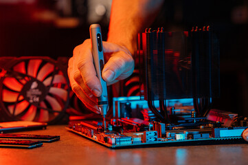 A set of parts for assembling and repairing a computer. Angle from above, everything is on the table, laid out, neon light