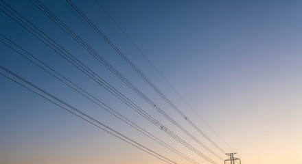 High voltage power lines against a sunset gradient. Electrical transmission tower silhouette. Industrial energy grid infrastructure. Technology network and connectivity concept for business