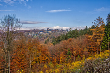 a beautiful hiking area in Solingen with a great view of the autumnal forest under blue skies
