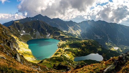 Stunning aerial view of mountains and lakes under a dramatic cloudy sky