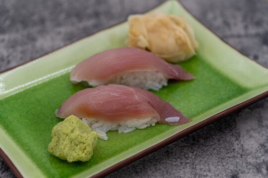 Sushi plate with a pair of yellowtail nigiri as an appetizer for an Asian meal