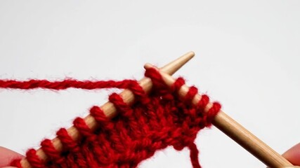 Step-by-step knitting process demonstrated with vivid red yarn and wooden needles showing - Powered by Adobe