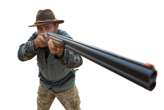 Hunter man in camouflage with a gun during the hunt in search of wild birds or game. Autumn hunting season.