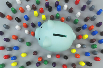 Top view of blue piggy bank and many different people figures. Savings, investment, funding and budget concept.
