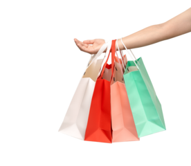 A person's hand holding a paper shopping bag with handles on a clean white background. Studio shot with ample copy space for text, logos, or branding. Isolated on white, cut out.