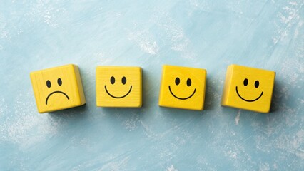 Yellow wooden blocks with happy faces arranged in a row