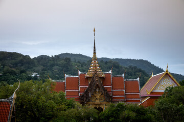 An old beautiful Buddhist temple on a background of trees. Ancient Asian architecture. Temple in Thailand.	
