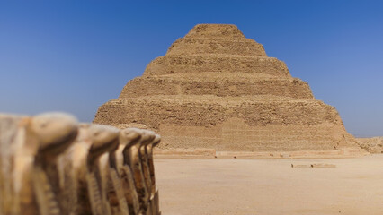 The Step Pyramid of Djoser in Egypt under a clear blue sky, showcasing ancient architecture and history during a travel vacation.
