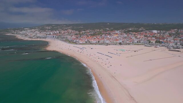 Aerial footage of  the beach of Figueira da Foz and the city, It is a coastal city with several beaches, summer and seaport facilities on the Atlantic Ocean coast.