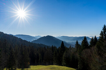 hazy layers of the mountain ridges  in the Lecknertal near Hittisau in Bregenzer Wald in Vorarlberg Austria in autumn light of the setting sun