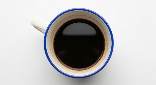 Top view of a fresh black coffee in a ceramic mug. Minimalist beverage concept for a cafe menu or morning routine. Caffeine boost for energy and productivity. Simple breakfast drink