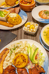 An authentic Ecuadorian encebollado showcases its generous chunk of tuna, boiled yucca, and pickled onions in an aromatic yellow broth, served in a clay bowl