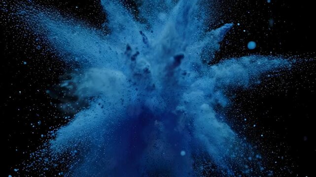 An abstract image capturing a splash of blue particles against a stark, dark background
