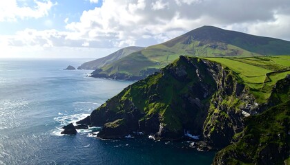 Stunning scenic coastal landscape featuring mountains and ocean under a cloudy sky