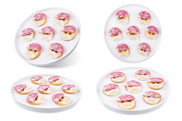 Salami sausage and cheese slices and crackers in the form of Santa Claus for Christmas holidays on a white isolated background