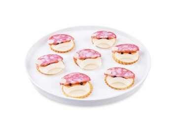 Salami sausage and cheese slices and crackers in the form of Santa Claus for Christmas holidays on a white isolated background