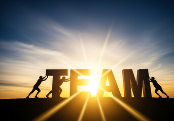 Teamwork concept with silhouettes pushing large letters collaborative effort against a bright sunset symbolizing unity and success