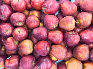 Fresh red washington apples piled together in a vibrant market display