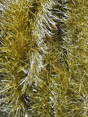 Background of a pile of shiny gold and silver tinsel. Handcrafted of combination gold and silver colored tinsel slinger made of shiny metallic plastic for various festive occasions or events.
