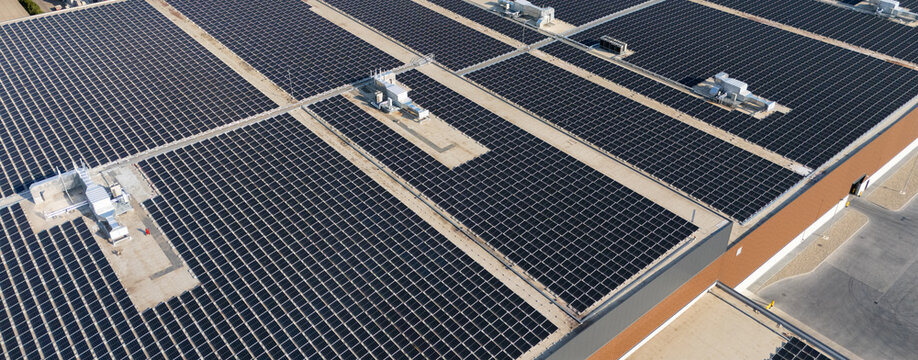 Solar panels on a roof of industrial building. Aerial view