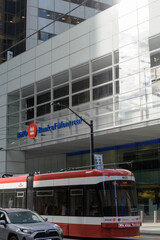 Fototapeta premium car and streetcar stopped in eastbound lane on King St W outside First Canadian Place, BMO, Bank of Montreal branch, at Bay, Toronto