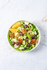 Fresh Waldorf salad, celery stalk with chicken, apple and walnuts, grapes, herbs, homemade, without people,