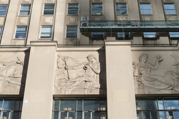 Fototapeta premium bas relief stone panels by Frederick Winkler on the exterior of the historic Bank of Nova Scotia (Bay St side), Toronto