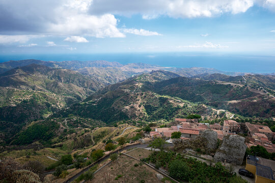 Panoramic view of the Aspromonte mountains and the Ionian Sea coast near Bova, Calabria, southern Italy with traditional hilltop village and layered Mediterranean landscape
