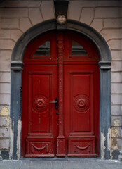 Ornate old town doors marked by time, featuring intricate details and weathered textures. The image reflects historical architecture, craftsmanship, and the quiet charm of aged elegance.